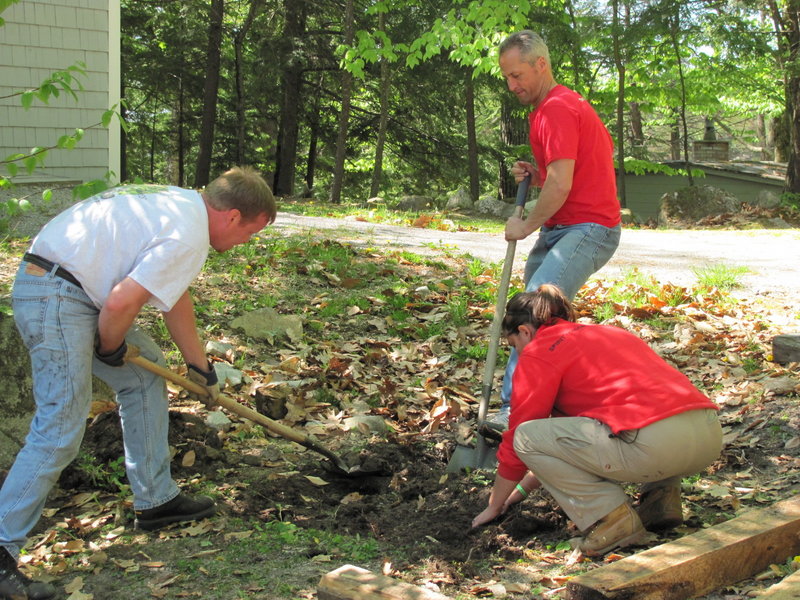 Volunteers do some landscaping work at Camp Sunshine as part of the Harvard Pilgrim Day of Service in May. The team also built a disc golf course for the camp.