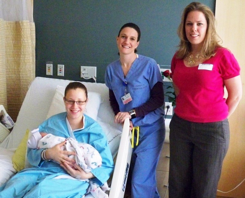 Alena Sarkisov of Portland and her baby, who was born on Mother’s Day; attending nurse Michelle Olkkola of Woolwich; and Inn by the Sea spa manager Malina Payne.