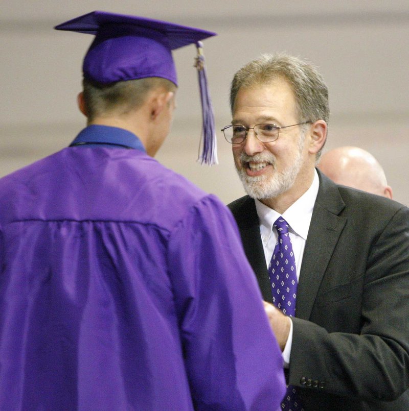Deering High School Principal Ken Kunin hands out a diploma during the graduation ceremony at the Portland Expo on Thursday.