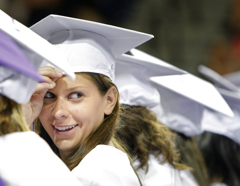 Deering High School senior Kate Armitage beams at another senior during the Portland school's graduation ceremony at the Portland Expo on Thursday. In all, 257 seniors earned their diplomas.