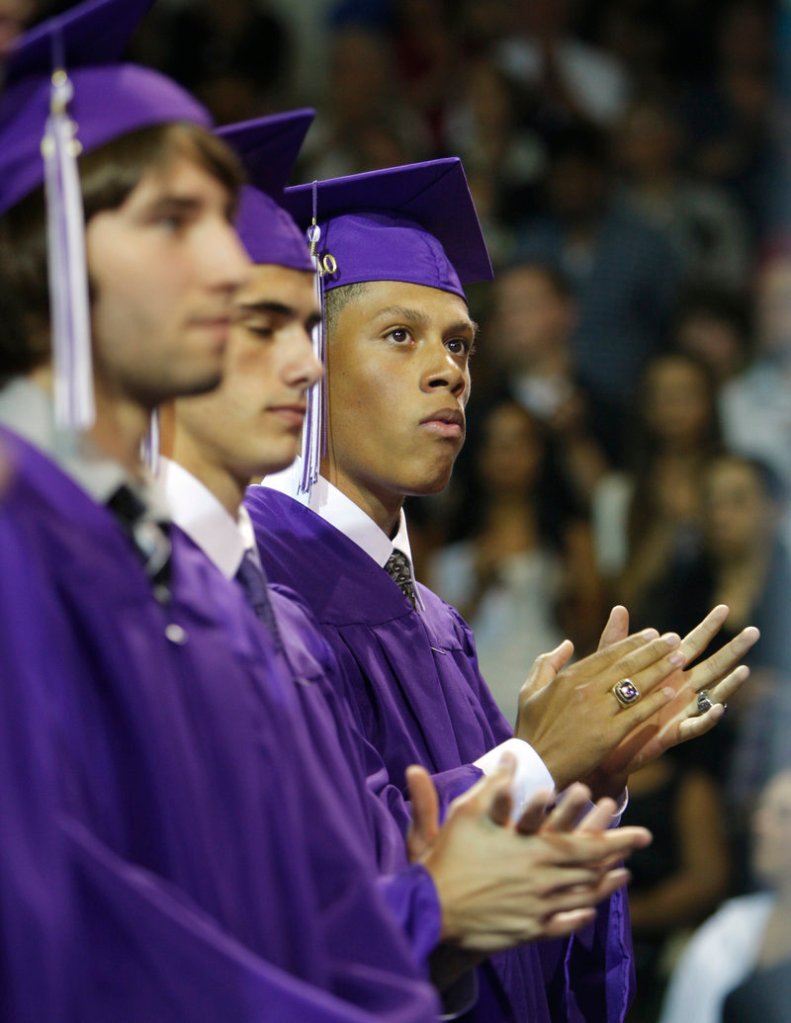 Deering High School senior Anthony Stewart claps at Deering’s graduation ceremony on Thursday while a diploma is awarded posthumously to Farhad Maharov, a student who died in then past year.