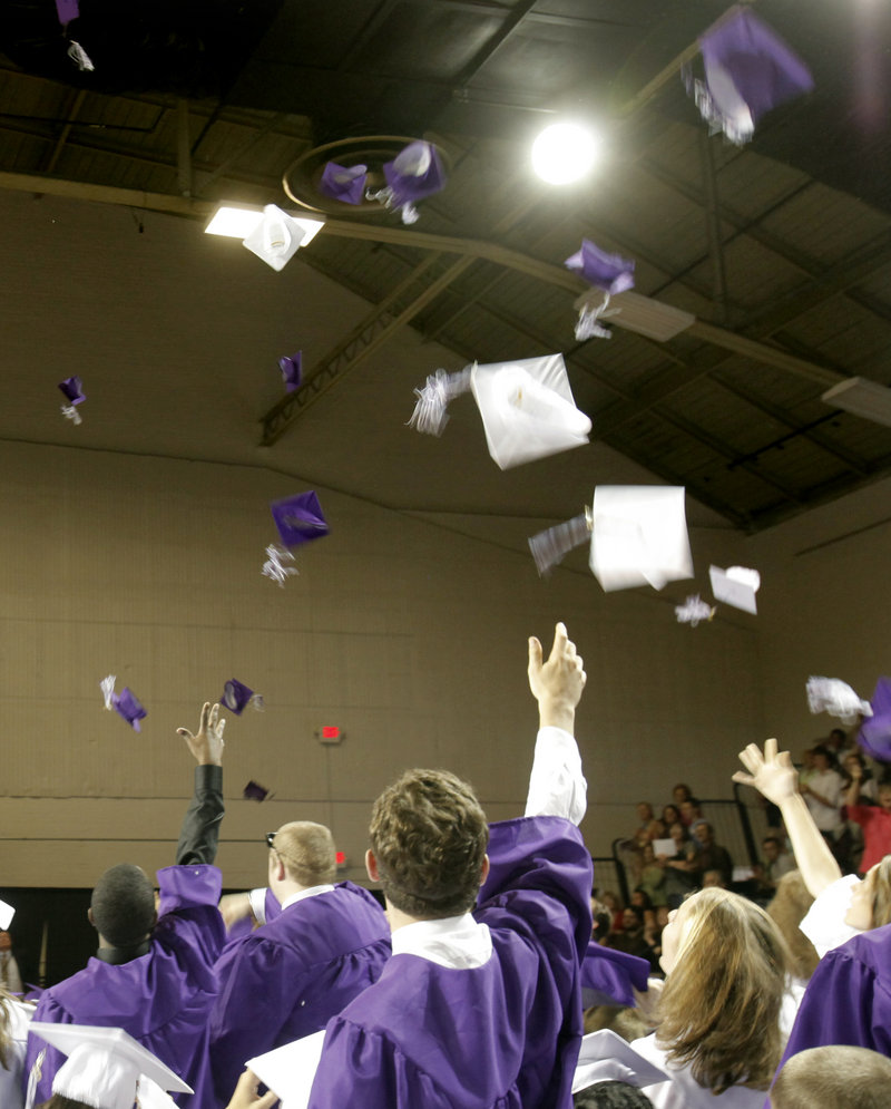 Mortarboards sail toward the roof of the Portland Expo as Deering High School seniors celebrate at the end of their graduation ceremony.