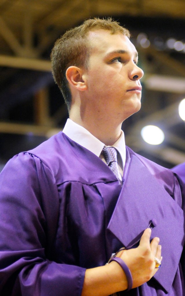 Deering High School senior Matt Caiazzo stands for the national anthem Thursday at the Portland Expo.