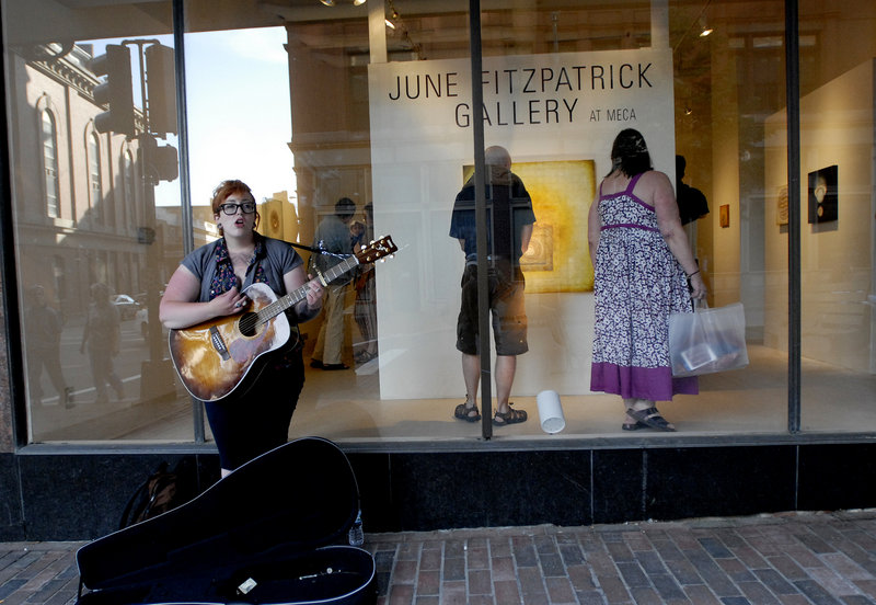Elizabeth Taillon of Portland performs on the sidewalk outside June Fitzpatrick Gallery during the First Friday Art Walk.