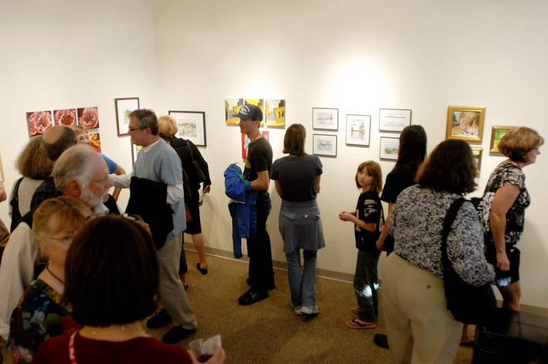Crowds flock into Bridge Gallery on Congress Street, one of 65 participating in the First Friday Art Walk.