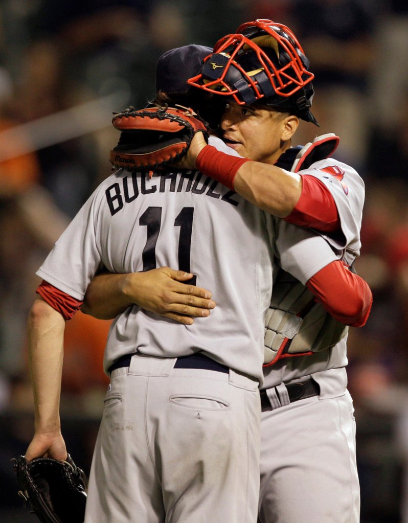 Clay Buchholz savors the win with catcher Victor Martinez on Friday night. Buchholz gave up five hits, struck out one and walked two in the complete-game shutout, his first shutout since he no-hit the Orioles on Sept. 1, 2007.