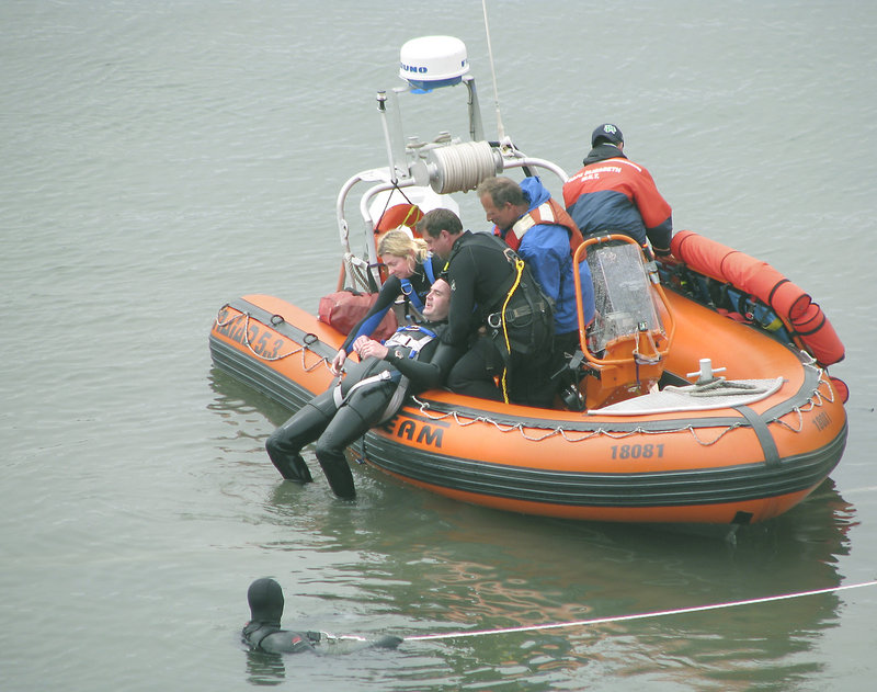 Rescue crews remove a ‘victim’ from the water during the full-scale aircraft emergency drill in the Fore River on Saturday.