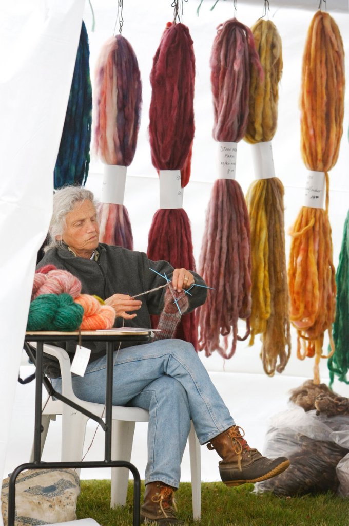 Elaine Graf of Fayette knits with a wool/mohair blend at one of the displays on Saturday.