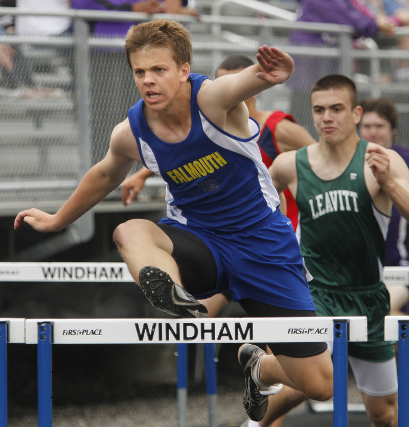 Alec Dunn of Falmouth leads the way in a 110 hurdles heat Saturday. He went on to win the state title in the Class B meet.