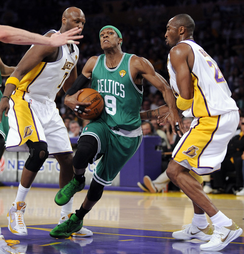 Rajon Rondo drives between Lamar Odom, left, and Kobe Bryant during Boston’s 103-94 win Sunday night. Rondo finished with 19 points, 10 assists and 12 rebounds.