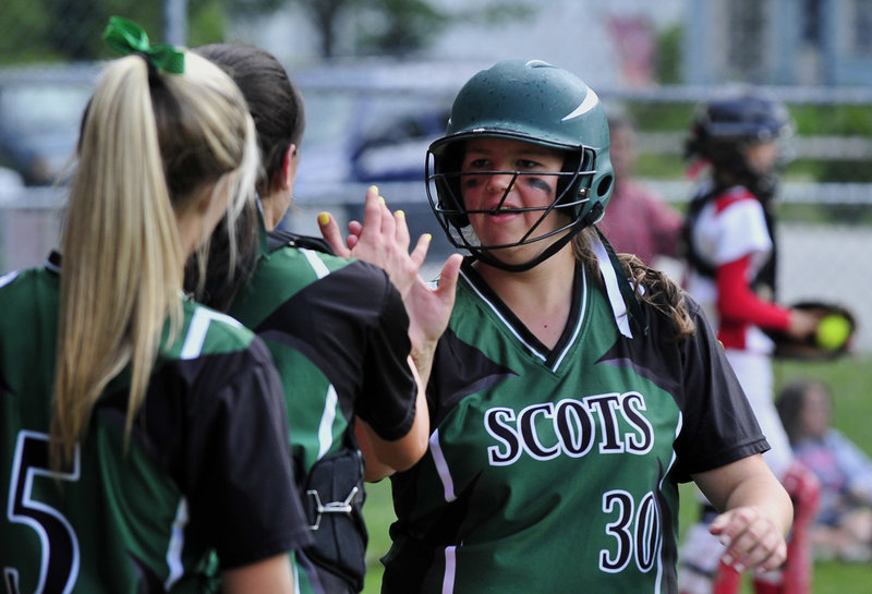 Lindsay Somerset of Bonny Eagle receives congratulations from teammates Tuesday after scoring during the 9-0 victory against Sanford in a Western Class A tournament game.