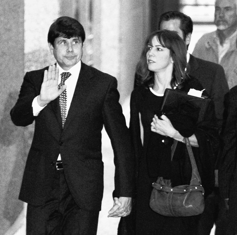 Former Illinois Gov. Rod Blagojevich departs the Federal Court building in Chicago Tuesday with his wife Patti, after opening arguments in his federal corruption trial. His lawyer said Blagojevich was the dupe of members of his inner circle.