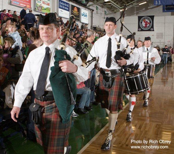 The Claddagh Mhor Pipe Band marches off the basketball court after its performance during a Maine Red Claws basketball game. Pictured, from left, are Ray O'Donnell, Paul Halvorsen, Jodi Ryan and Donald Oakes.