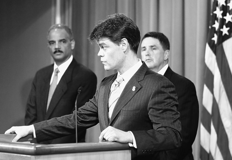 Attorney General Eric Holder, left, listens as U.S. Immigration and Customs Enforcement Assistant Secretary John Morton speaks during a news conference announcing the arrests of more than 2,200 people on drug-related charges Thursday.