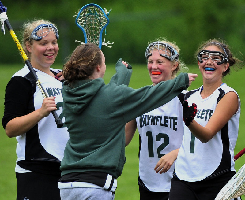 There was plenty to celebrate Thursday for the Waynflete girls’ lacrosse team. Included in the celebration were Liz Lewis, left; Lucy Crane, 12; and Mica Thompson, right.