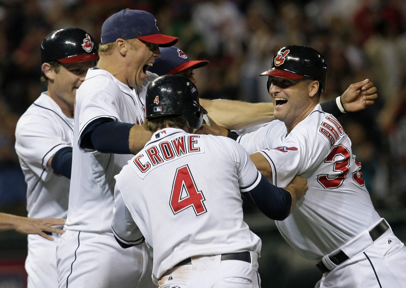 Russell Branyan is mobbed by his Cleveland Indians teammates Thursday night after looping a two-out, two-run single to right field off Daniel Bard to beat the Boston Red Sox, 8-7.