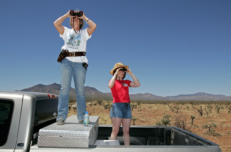 Carmen Mercer, left, of Tombstone, Ariz., and Lisa Hall of Chicago patrol the southwestern desert near Sasabe, Ariz., in this 2006 file photo. Both women are part of the Minuteman Project monitoring the border.