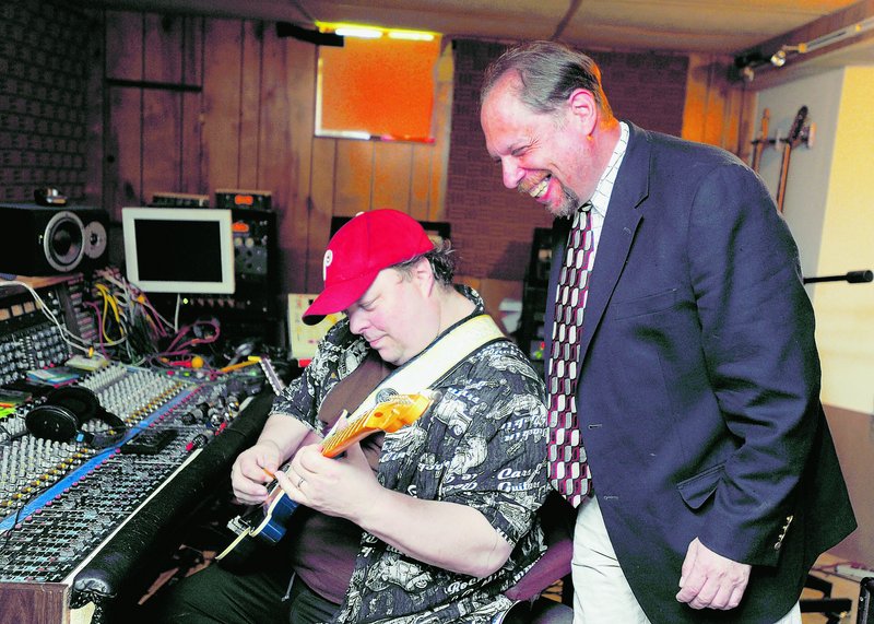 Richard Siegel, right, records a political satire song at a recording studio in Laurel, Md., with the help of Garrick Alden, a music engineer and producer. Siegel is a comedian and comedy club promoter whose income was halved in the recession.