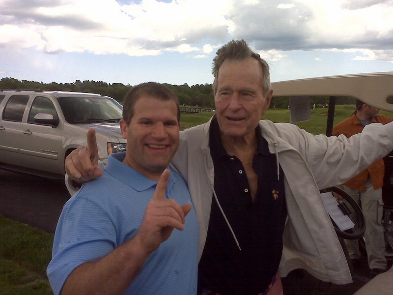 Rob Hatch of Buxton celebrates his hole-in-one with former president George H.W. Bush on Tuesday. Hatch was playing in Bush’s fundraising tournament at Cape Arundel.
