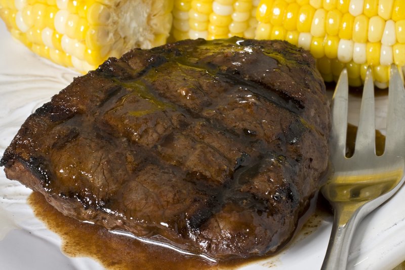 Bison steaks with balsamic-tamarind rub and garlic-paprika grilled corn make a simple weeknight meal that’ll give your next barbecuing event a sense of adventure.