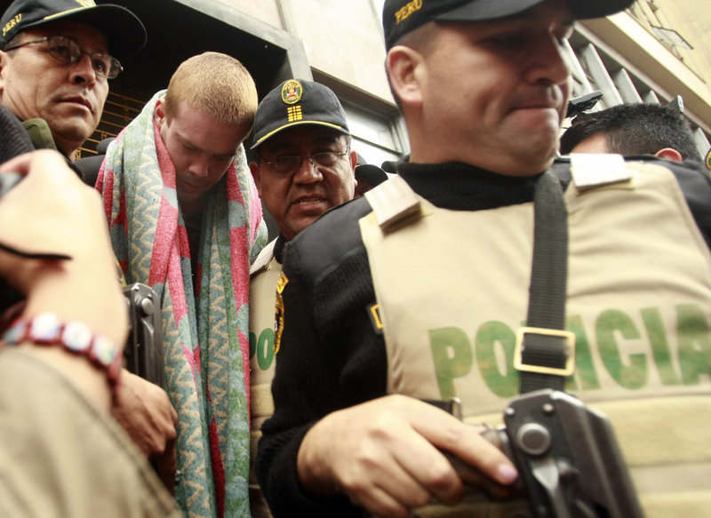 Joran van der Sloot, second from left, is escorted by police officers in Lima, Peru, on Friday. Peru’s criminal police chief said that van der Sloot told interrogators he knows the location of the body of a U.S. teen who vanished on Aruba in 2005.