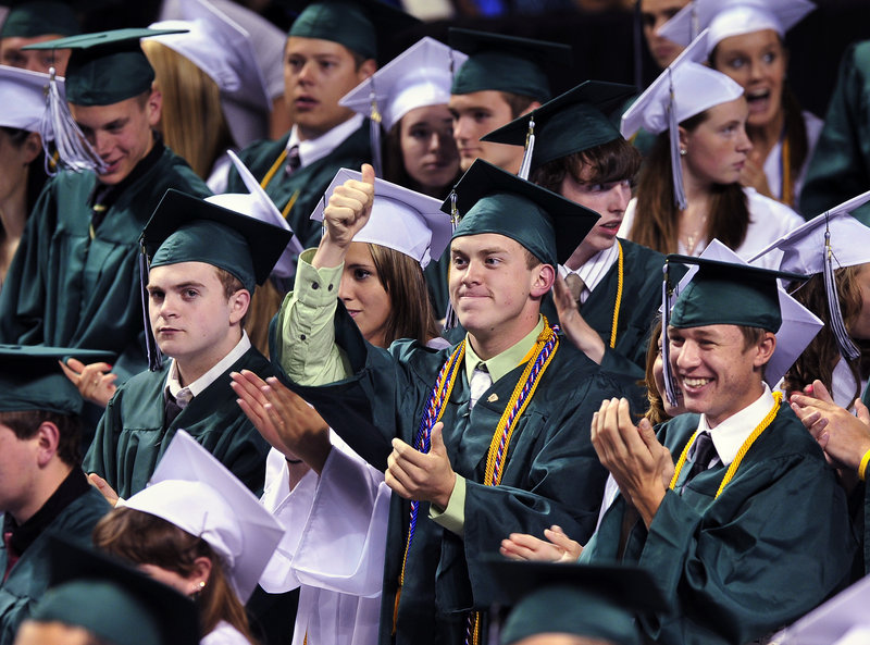 Surrounded by applauding classmates, class treasurer Robert Michaud gives the thumbs-up to class president K. Eliot Douin after his address at Bonny Eagle High School’s graduation Friday at the Cumberland County Civic Center.