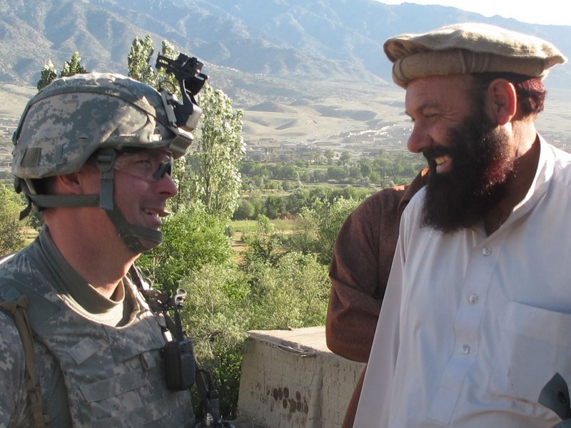 Bravo Company commander Capt. Paul Bosse of Auburn chats with a local elder during Saturday's search operation. No weapons were found, but a man suspected of Taliban ties was detained.