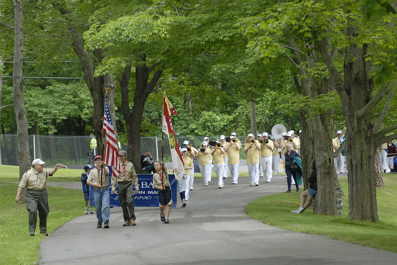 The Family Fun Day parade makes its way into Fort Williams Park Saturday, led by members of Boy Scout Troop 30, including from left, A.J. DiNinno, a troop committee member, and Timmy DiNinno, 14; Brendan Stewart, 17; and Jack Misterovich, 11, all of Cape Elizabeth. The Alumni Band follows the Scouts.
