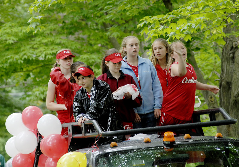 Members of the Cardinals softball team ride in the Family Fun Day parade.