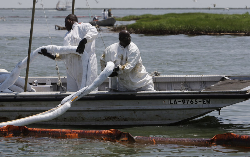 A crew replaces absorbent boom near a bird colony Saturday in Barataria Bay, La., to protect it from oil from the Deepwater Horizon spill. Unlike other countries, the U.S. doesn’t require oil companies to have relief well plans before drilling for oil.