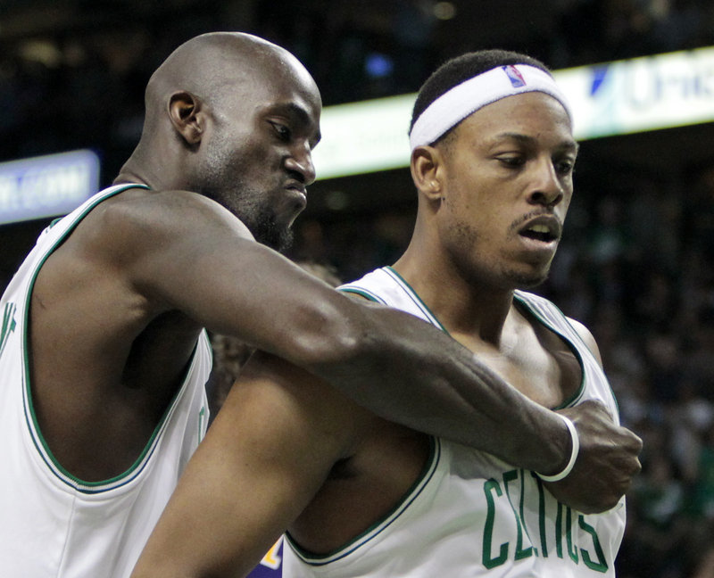 Boston Celtics forward Kevin Garnett, left, pounds the chest of teammate Paul Pierce during the fourth quarter of Game 4 of the NBA finals. The Celtics won 96-89 to even the series.