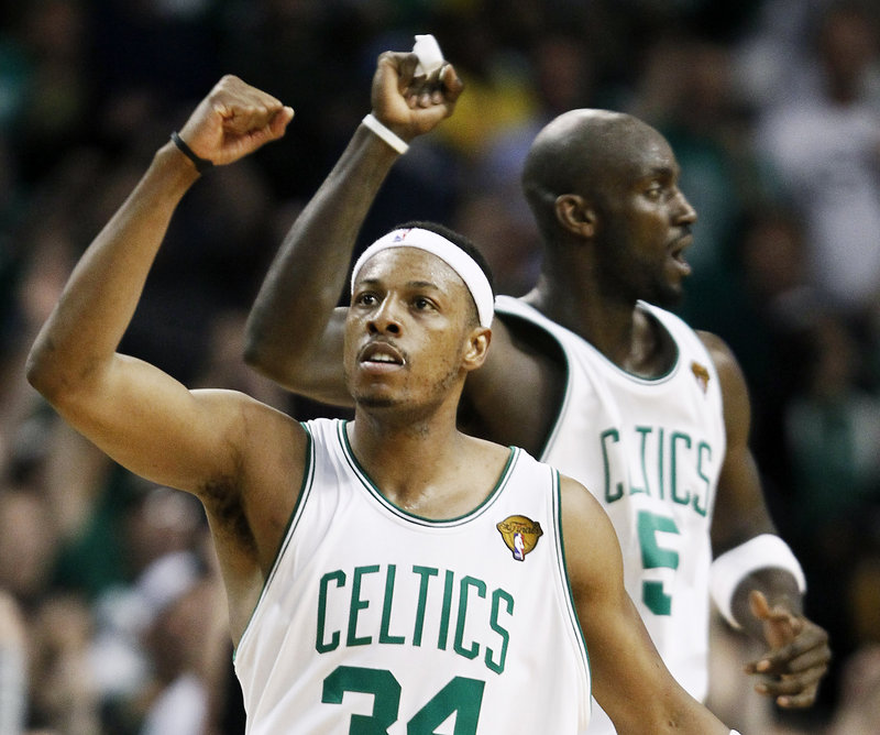 Paul Pierce, front, and Kevin Garnett celebrate the Celtics’ 92-86 win over the Lakers in Game 5 of the NBA finals Sunday night in Boston. Pierce, who scored 27 points, said, “We’ve got to get one (win). We’re too close to our goal. We’ve got to get one.” Game 6 is Tuesday.