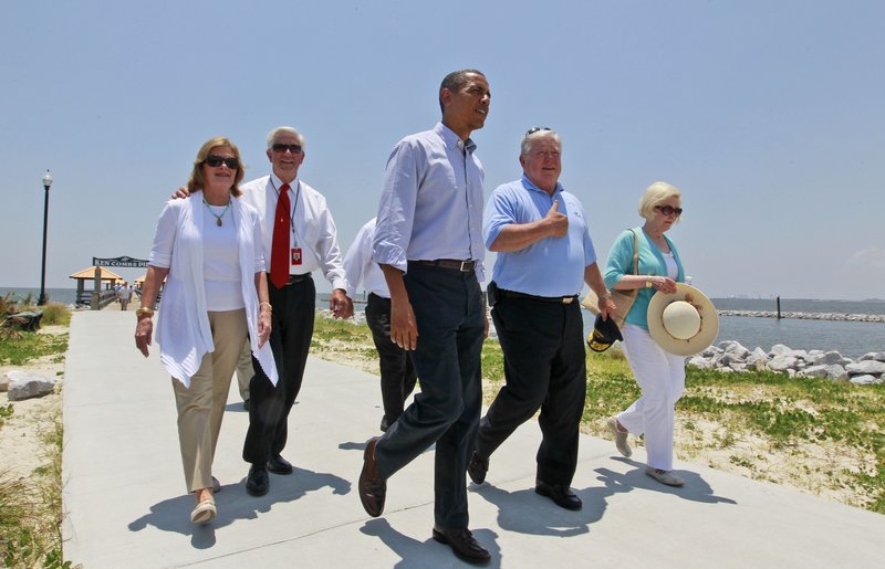 President Obama walks with Mississippi Gov. Haley Barbour, second from right, and Gulfport Mayor George Schloegel, second from left, after meeting with residents affected by the BP Deepwater Horizon oil spill on Monday in Gulfport, Miss. Peggy Schloegel, the mayor's wife is at left, Marsha Barbour, the governor's wife is at right.