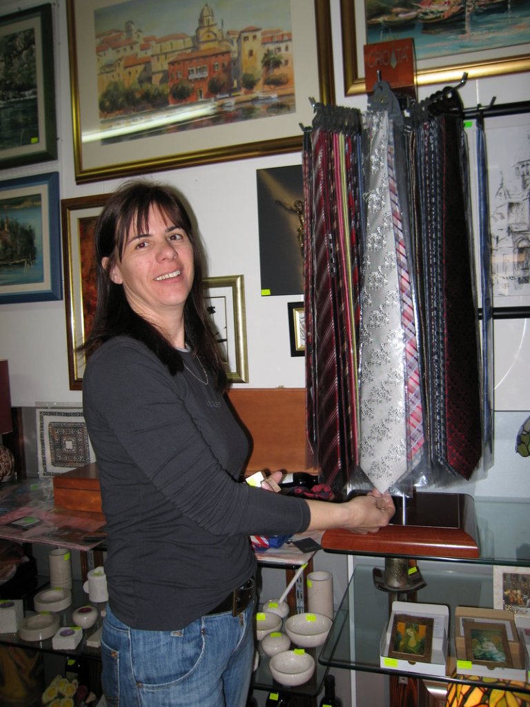 A saleswoman points to a tie at a shop in Sibenik, Croatia.