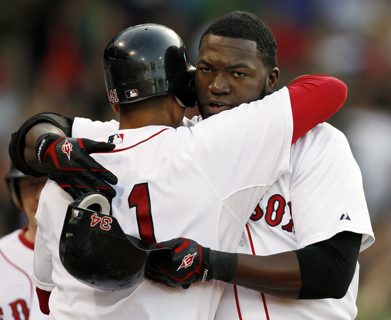 David Ortiz of the Red Sox receives a hug from Victor Martinez after hitting a two-run homer in the first inning of the 6-3 victory against the Diamondbacks.