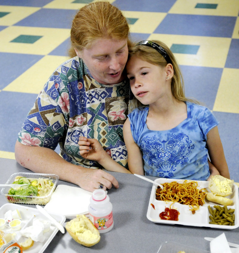 Vicki McMahan and her daughter, Cheyennee, 8, eat a spaghetti dinner Wednesday at Lincoln Middle School on Stevens Avenue in Portland as part of a summer nutrition program sponsored by the Portland Public Schools Food Service and the Wayside Community Food Program.