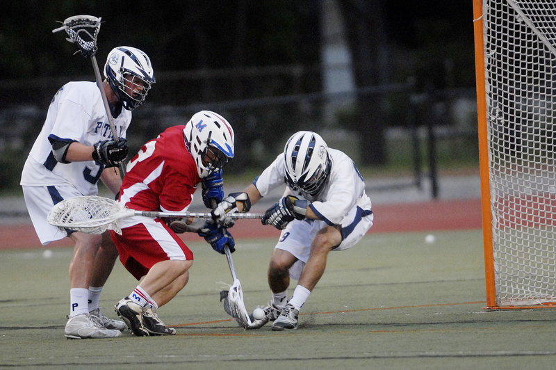 Luke Vigue of Messalonskee attempts to put the ball past Ryan Jurgelevich, who made 13 saves for Portland. The Bulldogs will play Scarborough in the state final Saturday.
