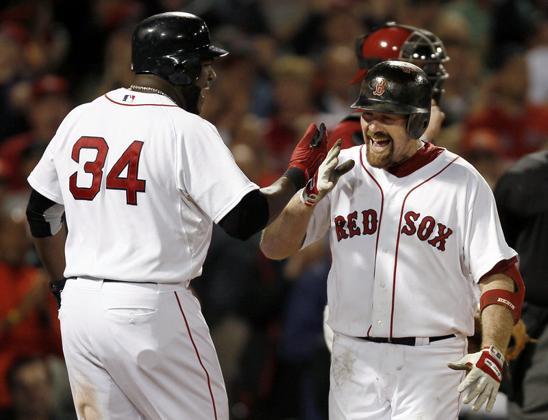 Kevin Youkilis of the Boston Red Sox, right, receives congratulations from David Ortiz after hitting a two-run homer Wednesday night in the seventh inning of the 6-2 victory against the Arizona Diamondbacks at Fenway Park.