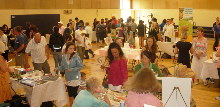 Attendees chat with exhibitors and enjoy free food samples at the 2009 Vegetarian and Vegan Food Fesitval.