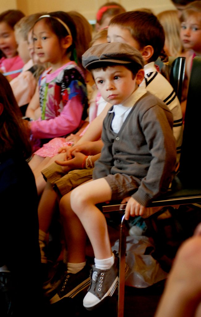 Louison Carribou, 3, a pre-schooler at the school, listens during end of year ceremonieson Thursday.