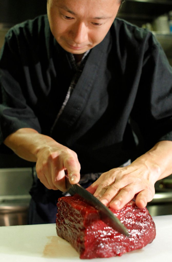 Whale meat is sliced in a Tokyo restaurant. Japan has a scientific exemption to hunt whales in a sanctuary, but much of the catch is eaten.