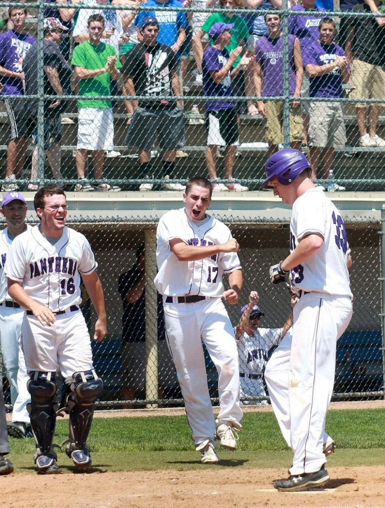 Tim Locke of Waterville is welcomed by catcher Brendan Scully and Kyle Bishop after hitting a solo home run in the fifth inning Saturday. The Purple Panthers went on to down Cape Elizabeth 9-5 in the Class B state final at Bangor.