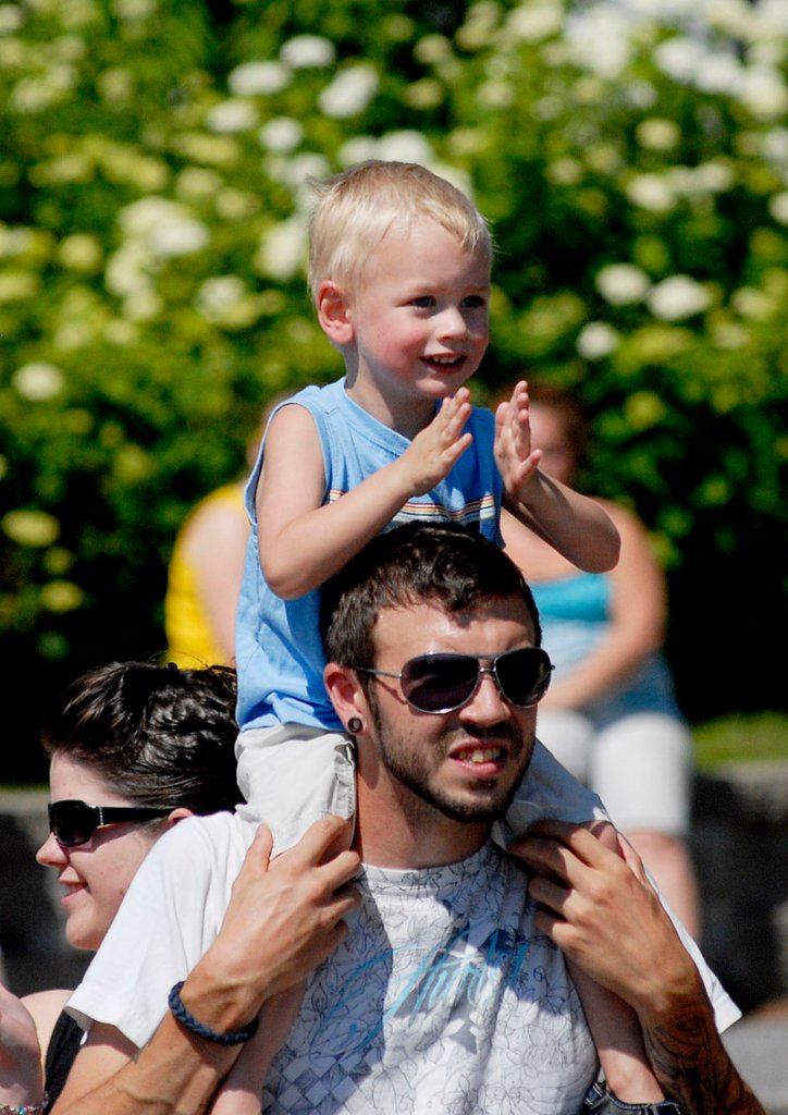 Three-year-old Myles Willette of Windham enjoys the parade from the shoulders of his father, Nathan Willette.
