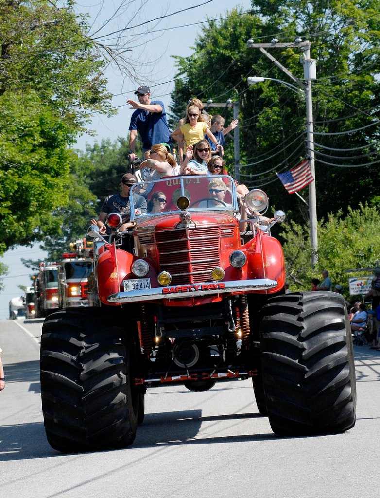 Camp Sunshine's entry precedes a fleet of firetrucks during Windham's Summerfest-launching parade Saturday. The organization also hosted a free Kids Zone with games for tots.