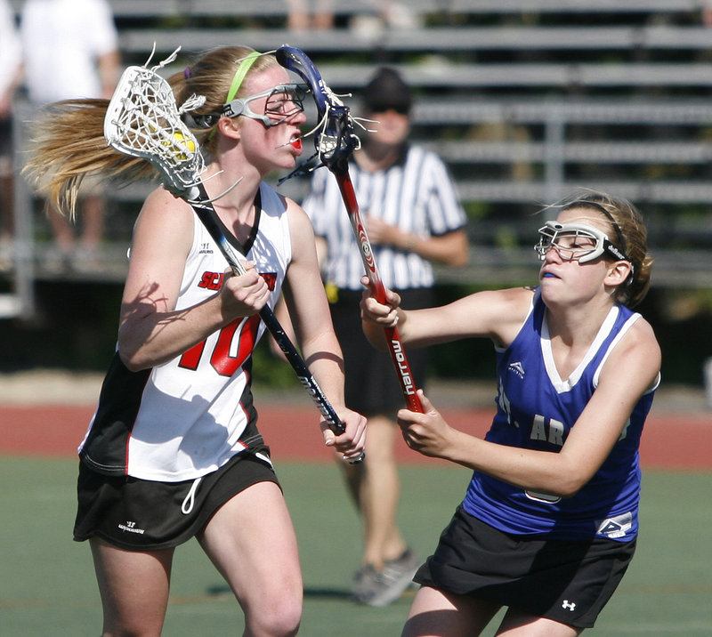 Maggie Smith, left, of Scarborough looks to get around the defense of Maggie Bouchard of Mt. Ararat on Saturday in the Class A state championship game at Fitzpatrick Stadium. The Red Storm capped an unbeaten season with an 11-7 victory.