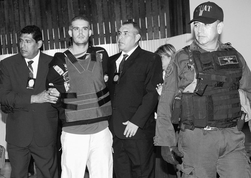 Police escort Joran Van der Sloot, second from left, during a news conference at a police station in Lima earlier this month. The young Dutchman, charged with the murder of a 21-year-old Peruvian woman, remains the lone suspect in the 2005 disappearance of U.S. teenager Natalee Holloway.