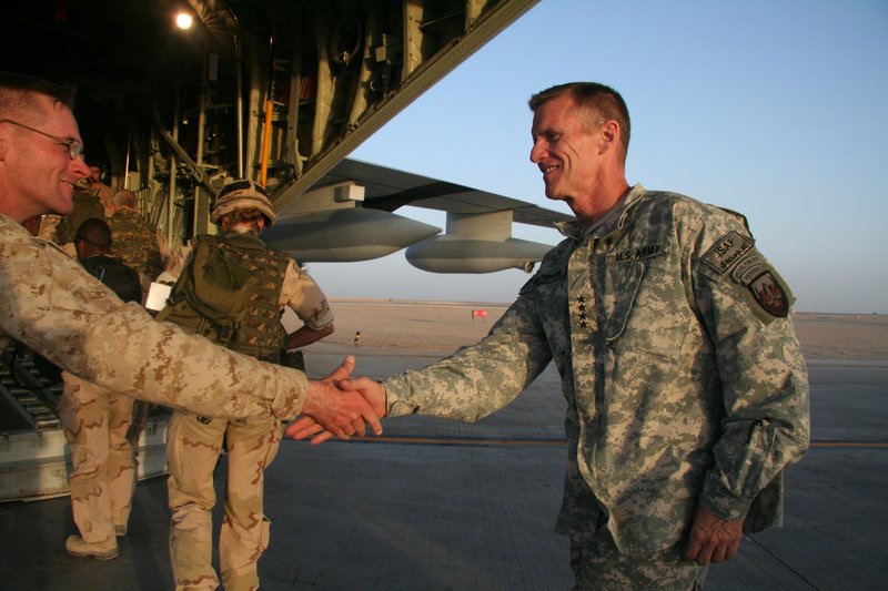 U.S. Gen. Stanley McChrystal, right, shakes hands with a Marine before boarding a military plane last year at Camp Leatherneck base in the southern province of Helmand, Afghanistan. McChrystal’s job as the war’s U.S. commander appeared in jeopardy Tuesday as an infuriated President Obama summoned him to Washington.