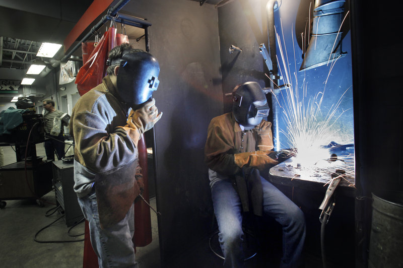 Joel Boehm, 14, welds a sculpture together as Griffin Klene, 17, watches on Wednesday. The two are taking part in the Mind Over Metal manufacturing skills camp at Southern Maine Community College this week.