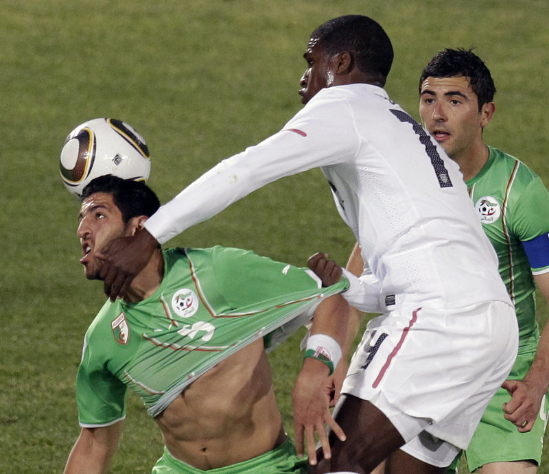 Edson Buddle, right, of the United States contends for the ball with Rafik Halliche of Algeria Wednesday during the 1-0 victory for the U.S., which will meet Ghana next.