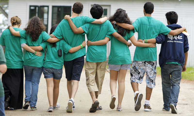 Campers leave the opening ceremony for the Seeds of Peace camp in Otisfield on Thursday. For three weeks, more than 150 youths from Israel, the Palestinian Territories, Egypt, Jordan, Afghanistan, Pakistan, India and the United States will learn from each other.